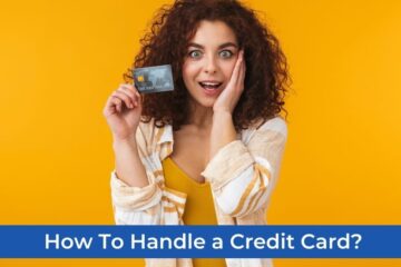 A girl with curly hair is delighted while holding a credit card in her left hand.