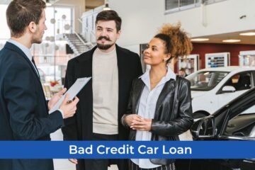A mortgage lender is talking to a man and woman about their car loan while they are also in the way of choosing the right car for their whole family while they still have bad credit.
