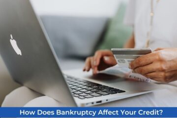 A person with a laptop on his front view with a paper and credit card also involves taking care of credit after being involved in bankruptcy.