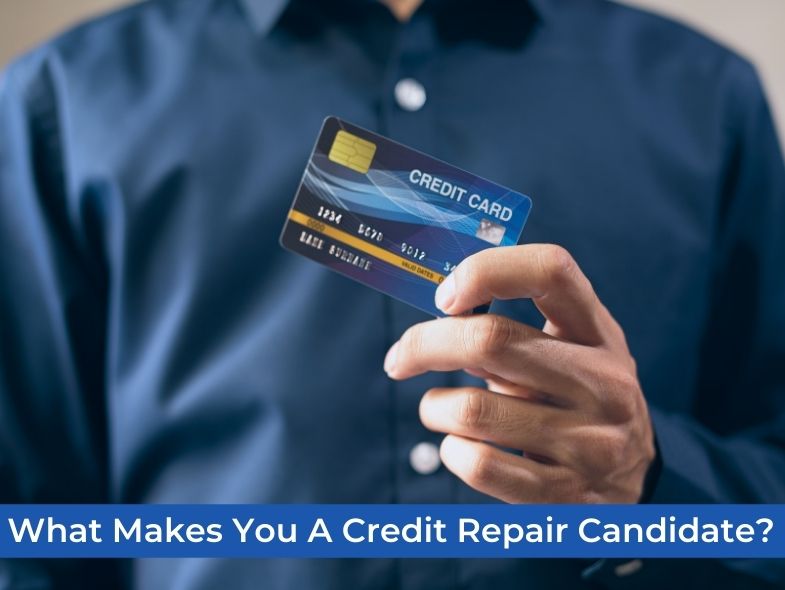 A man is holding a credit card in his left hand.